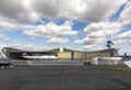 Lufthansa maintenance hall in butterfly construction with parking Boeing 747 and an Airbus in front and passing crew bus Royalty Free Stock Photo