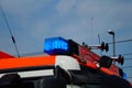 Flashing blue light and siren on the roof of a fire engine. Royalty Free Stock Photo