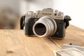 FRANKFURT, GERMANY - JUNE 2020: FUJIFILM XT4 digital camera with Fujinon lens, vintage photographs on old wood background,