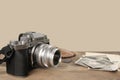 FRANKFURT, GERMANY - JUNE 2020: FUJIFILM XT4 digital camera with Fujinon lens, vintage photographs on old wood background,