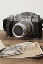 FRANKFURT, GERMANY - JUNE 2020: FUJIFILM XT4 with Fujinon lens, vintage photographs on old wood background, photographic concept,