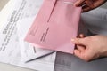 Frankfurt, Germany - March 2021: Male hands hold envelopes with a ballot paper for the Hessian local elections Frankfurt on March