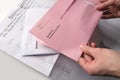 Frankfurt, Germany - March 2021: Male hands hold envelopes with a ballot paper for the Hessian local elections Frankfurt on March