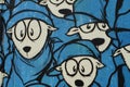 Graffito of a flock of sheep in blue clothing.