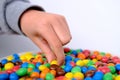 Frankfurt, Germany, October 2021: close-up of multi-colored button-shaped chocolates, each of which has letter
