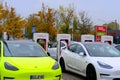 Frankfurt, Germany, October 2021: many Tesla light electric cars replenish battery at charging station, alternative energy
