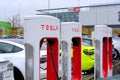 Frankfurt, Germany, October 2021: many Tesla light electric cars replenish battery at charging station, alternative energy