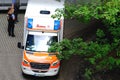 Frankfurt - June 2021: modern white ambulance car with flashing lights on roof at top is waiting for the patient, medics provide