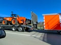Boels Rental truck loaded with mini grader on motorway. Royalty Free Stock Photo