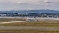 Apron, Taxiway, Runway and Terminal 2 at Frankfurt Main international airport with Lufthansa Cargo Boeing 777 lining up Runway 25C Royalty Free Stock Photo