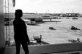 Frankfurt am Main, Germany - October 11, 2015: girl silhouette look at planes on airdrome ground on sunny day. Woman in Royalty Free Stock Photo