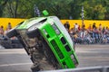 FRANKFURT AM MAIN, GERMANY - SEPT 2022: green BMW 325i E36 car rides sideways on two wheels, at an auto show, Monster Truck auto