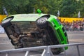 FRANKFURT AM MAIN, GERMANY - SEPT 2022: green BMW 325i E36 car rides sideways on two wheels, at an auto show, Monster Truck auto