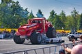 FRANKFURT AM MAIN, GERMANY - SEPT 2022: red Monster Truck Gasoline Tanker is crushing the car, Monster Truck auto show Royalty Free Stock Photo