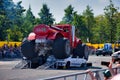 FRANKFURT AM MAIN, GERMANY - SEPT 2022: red Monster Truck Gasoline Tanker is crushing the car, Monster Truck auto show Royalty Free Stock Photo