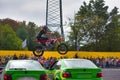 FRANKFURT AM MAIN, GERMANY - SEPT 2022: stuntman riding Honda CRF 450R is jumping over BMW 3er E36, Monster Truck auto show Royalty Free Stock Photo