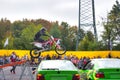 FRANKFURT AM MAIN, GERMANY - SEPT 2022: stuntman riding Honda CRF 450R is jumping over BMW 3er E36, Monster Truck auto show Royalty Free Stock Photo