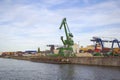 Frankfurt am Main, September 2018: port cargo crane on banks of river Main, rows of metal containers, concept of shipping from