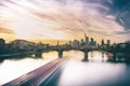 Sunset over the river Main in Frankfurt. View of the skyline with a bridge in the foreground. Cityscape in a long exposure