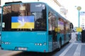 Frankfurt - March 2022: green urban shuttle bus at the bus stop with pacifist banners, an anti-war rally near Consulate General of