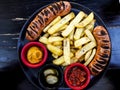 Frankfurter Sausage with potatoes, salsa sauce and mustard. Royalty Free Stock Photo