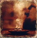 Frankincense burning on a hot coal. Aromatic frankincense. Old photo effect.