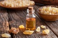 A bottle of frankincense essential oil with frankincense resin o Royalty Free Stock Photo