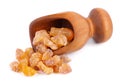 Frankincense resin in wooden scoop, isolated on white background. Pile of natural frankincense Olibanum. Incense.