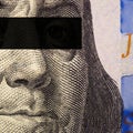 Franklin`s face close-up with a black stripe of censorship on his eyes on a fragment of a 100 dollar bill. Exchange rate of the Royalty Free Stock Photo