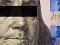 Franklin`s face close-up with a black stripe of censorship on his eyes on a fragment of a 100 dollar bill of the new sample. Royalty Free Stock Photo