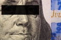 Franklin`s face close-up with a black stripe of censorship on his eyes on a fragment of a 100 dollar bill of the new sample Royalty Free Stock Photo