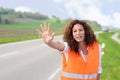 Frantic young woman trying to stop traffic Royalty Free Stock Photo
