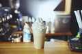 Frappe - iced latte coffee with caramel and chocolate syrup and whipped cream in cafe. Coffee break Royalty Free Stock Photo