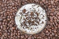 Frappuccino with ice in take away cup, with straws and grains of coffee on a wooden table, copy space Royalty Free Stock Photo