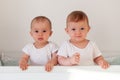 Fraternal twins sisters standing in crib Royalty Free Stock Photo