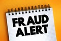 Fraud Alert text on notepad, concept background Royalty Free Stock Photo