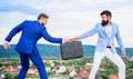 Fraud and extortion concept. Rascal racketeer extortionist cheating handover. Men suits handover briefcase. Business Royalty Free Stock Photo