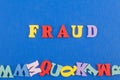 FRAUD word on blue background composed from colorful abc alphabet block wooden letters, copy space for ad text. Learning english