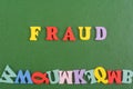 FRAUD word on green background composed from colorful abc alphabet block wooden letters, copy space for ad text. Learning english