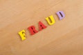 FRAUD word on wooden background composed from colorful abc alphabet block wooden letters, copy space for ad text. Learning english