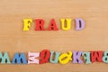 FRAUD word on wooden background composed from colorful abc alphabet block wooden letters, copy space for ad text. Learning english