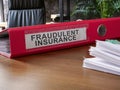 Fraudulent insurance documents on the desk.