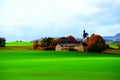 settlement and church Fraukirch with green field and bright autumn colored trees