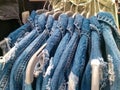 Frayed denim jacket jeans hang in store shop