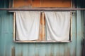 frayed, heavy stage curtains hanging from a rusted rail