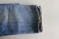 Frayed legs of a pair of faded jeans Royalty Free Stock Photo