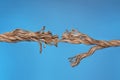 Frayed rope breaking on color background Royalty Free Stock Photo