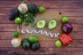 Frazzled face with halved avocado, fresh cilantro, and guacamole ingredients