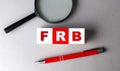 FRB word on wooden cubes with pen and magnifier Royalty Free Stock Photo