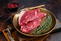 Freah Raw cap rump beef meat steak in a plate with thyme, top sirloin steak. Dark background. Top view Royalty Free Stock Photo